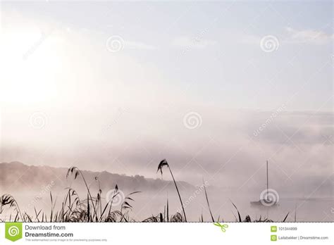 Morning Mist Over Lake With Sailboat Stock Image Image Of Sunrise