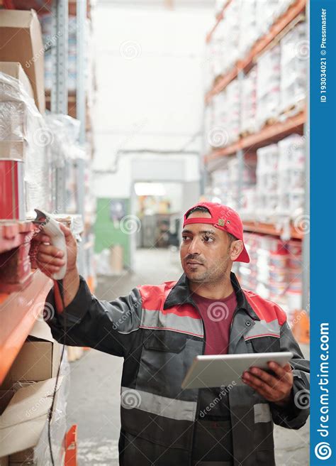 Mixed Race Male Worker Of Warehouse In Uniform Scanning Qr Codes On