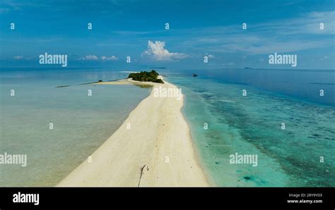 Sandy Tropical Island With A Beautiful Beach Surrounded By A Coral Reef