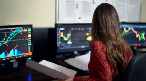 Finance Trader Woman Working In Office With Monitors Full Of Finance