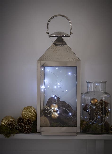 Twinkly Fairy Lights Placed Within A Tall Lantern Provide The Essential