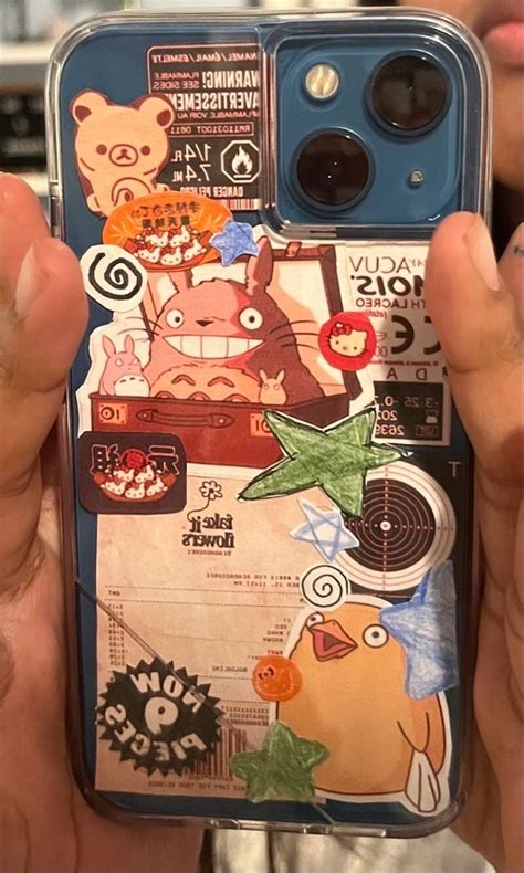 Someone Holding Up Their Phone Case With Stickers On It