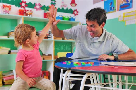 Preschool Teacher And Child Giving High Five Happy Preschool Teacher