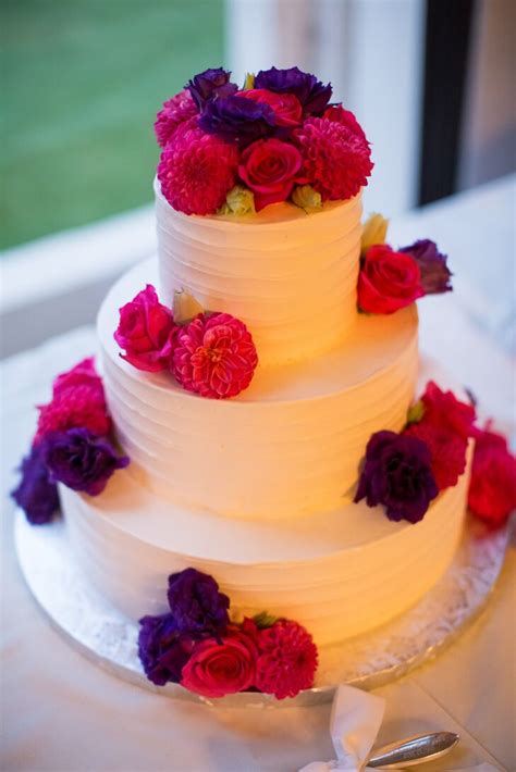 Bright Pink And Purple Flowers On Ivory Wedding Cake