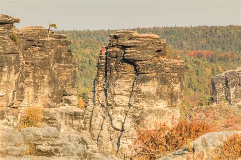 Elbe Sandstone Mountain In Autumn With Mountain Climber In Sunshine