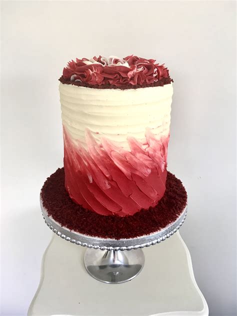 A Red And White Cake Sitting On Top Of A Table