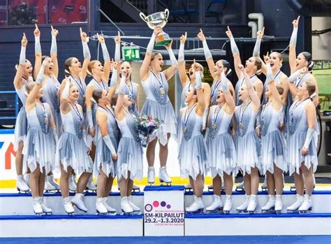 The Women S Ice Dance Team Is Holding Up Their Trophy