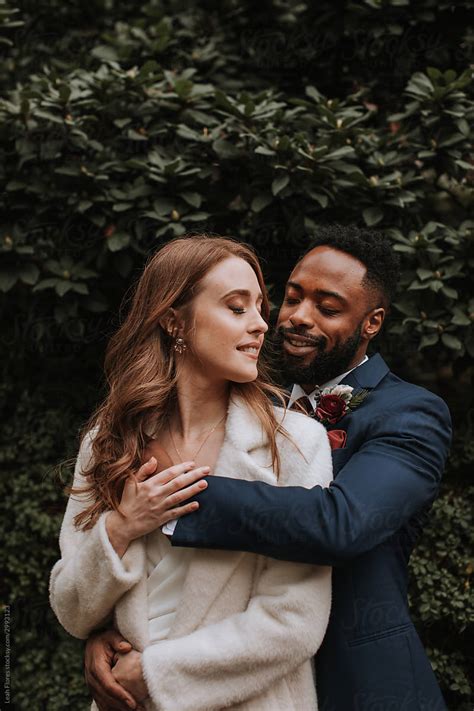 happy wedding couple embraced by stocksy contributor leah flores stocksy