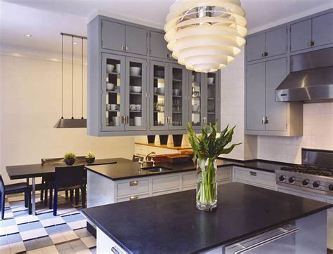 This is an example of a kitchen incorporating new kitchen with black cabinets throughout with light beige and dark brown granite. white cabinets with blue countertops | , blue, glass-front ...