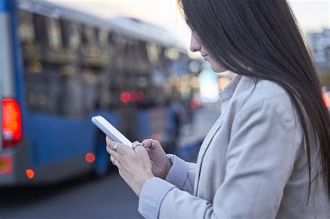 Premium Photo Young Girl Use Smartphone Waiting For Bus At Bus Stop