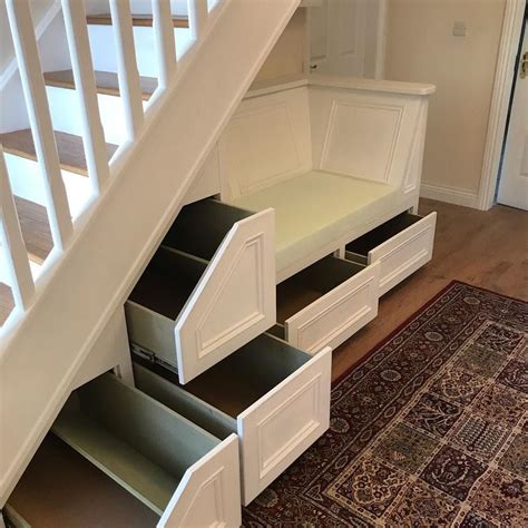 An Under Stairs Storage Unit With Drawers Underneath The Stair Railing