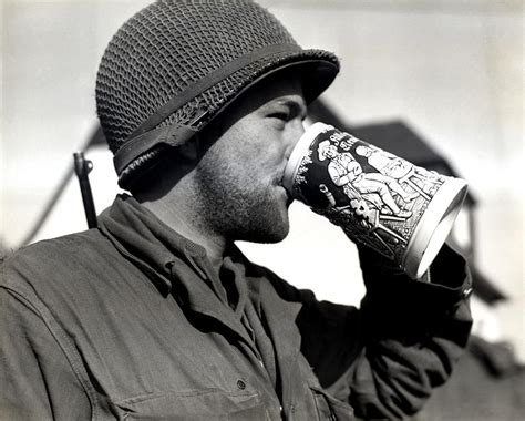 Wwii American Soldier Drinking Beer Photograph By Historic Image