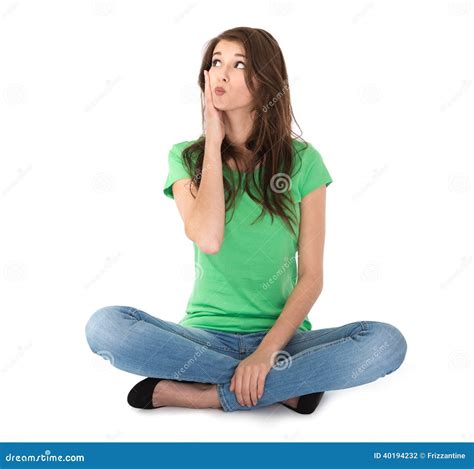Isolated Young Woman Sitting In Crossed Legs On The Floor Stock Photo