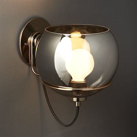 A Light That Is On The Side Of A Wall Mounted Fixture With A Glass Bowl