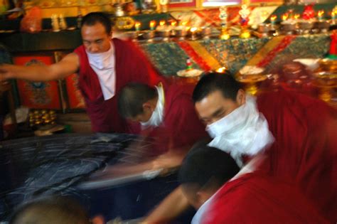 Tibetan Buddhist Monk Pours Blessed Water Wearing Khatags For Masks