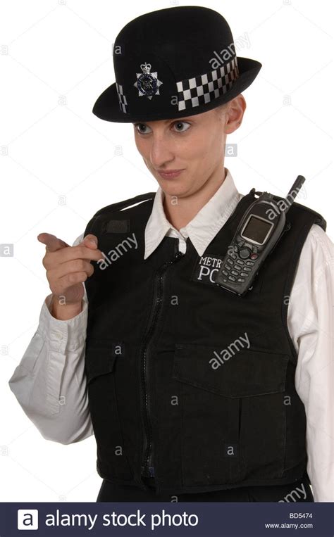 Uniformed Uk Female Police Officer In Ready Stance Holding