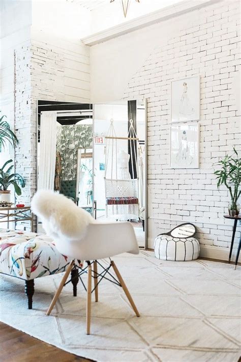 Elegant Retail Space With White Washed Bricks And A Large Mirror