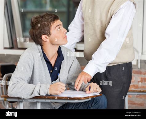 Teacher Explaining Test To Student In Classroom Stock Photo Alamy