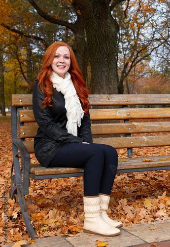 Redhead Girl In Autumn City Park Sit On Wood Bench One People Stock