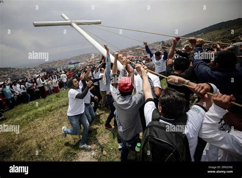 Faithful raise a cross near the Árbol de la Vida or Tree of Life during