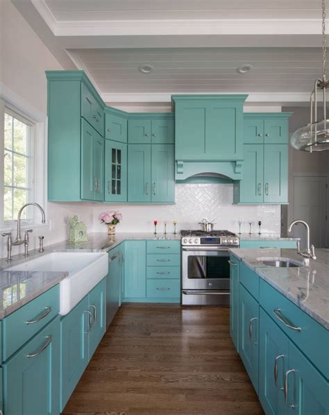 A Kitchen With Teal Cabinets And White Counter Tops Is Pictured In This
