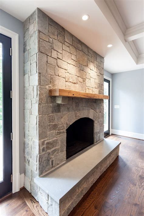 Natural Gray Stone Fireplace With Reclaimed Natural Wood Mantel And