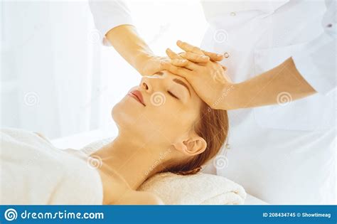 Beautiful Woman Enjoying Facial Massage With Closed Eyes In Sunny Spa Center Relaxing Treatment