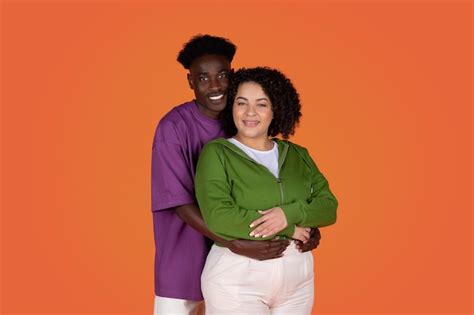 Premium Photo Studio Portrait Of Loving Mixed Race Couple Hugging On Red