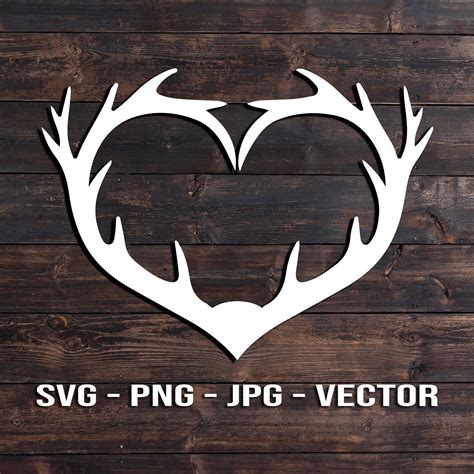 The Svg Png  Vector Heart With Antlers Is Shown On A Wooden