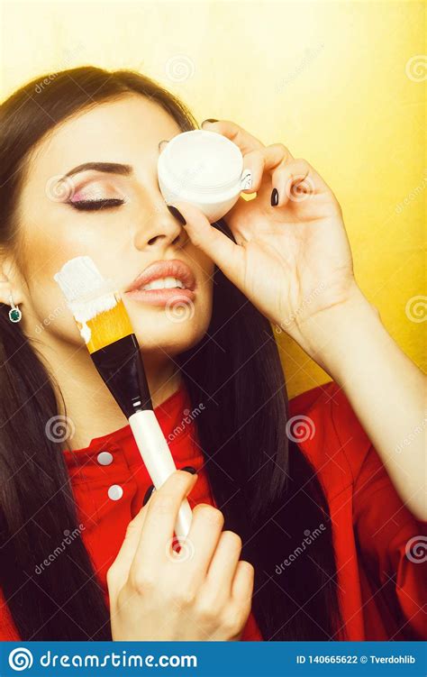 Pretty Brunette Woman Face With Artist Or Makeup Brush