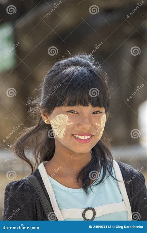 Happy Young Myanmar Girl With Thanaka On Her Smile Face On Street