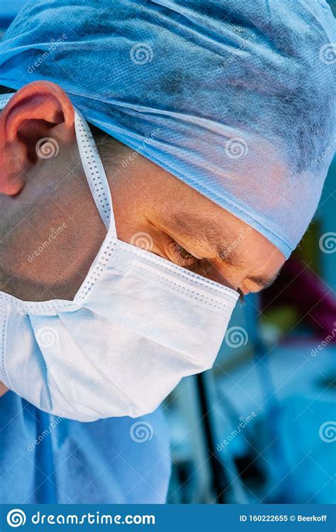 Close Up Of Male Surgeon Wearing Surgical Mask And Cap Stock Image