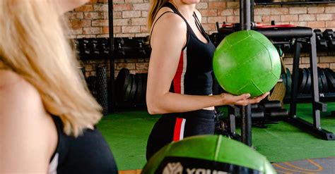 Photo Of Woman Smiling While Holding Green Exercise Ball · Free Stock Photo