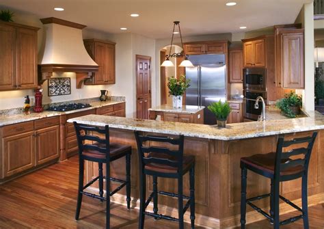 Download snack counter stock photos. This kitchen features staggered cabinet heights, a granite ...