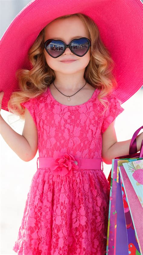 Small Cute Girl Is Wearing Pink Dress And Hat Having Bags