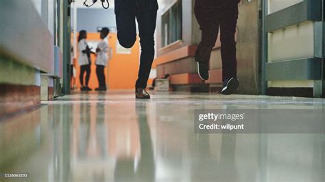 Legs Of Two Doctors On Call Running To Emergency In A Hospital Corridor