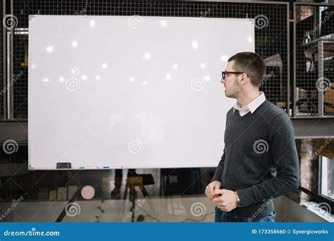 Male Lecturer With Marker Looking At A Whiteboard Stock Photo Image