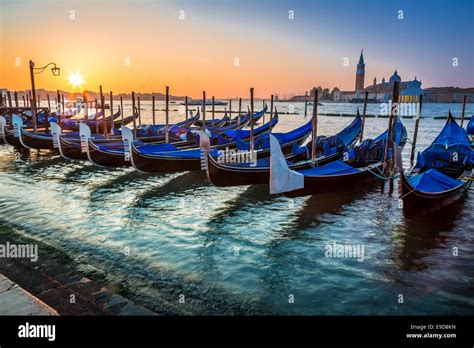 Blue Gondolas At Sunrise In Venice Stock Photo Alamy