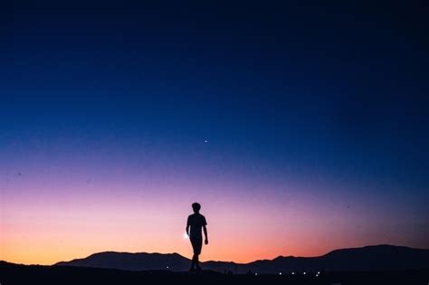 Premium Photo Silhouette Man Standing On Mountain Against Clear Sky