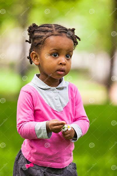 Outdoor Close Up Portrait Of A Cute Little Young Black Girl Stock Image