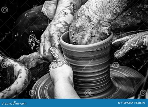 Hands Of Man Working And Shaping Clay Potter In Pottery Stock Photo