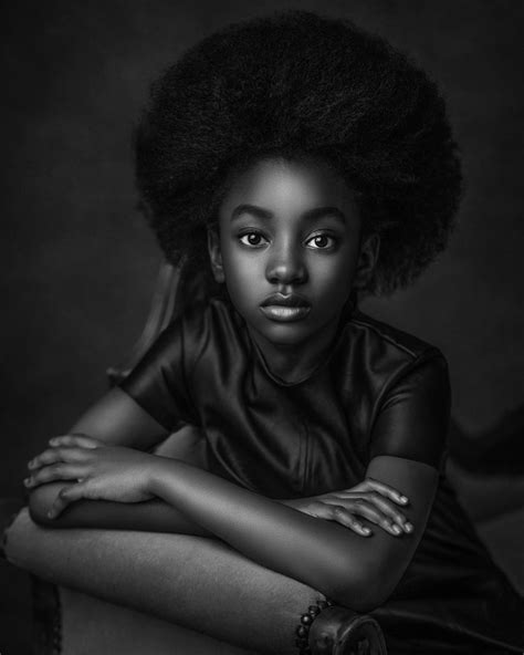 A Woman With An Afro Is Posing For A Black And White Photo She Has Her