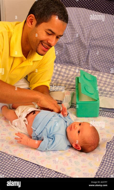African American Father Changing Newborn Son Diaper Stock Photo Alamy