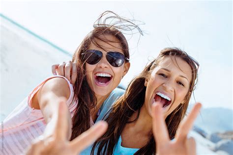 two girls having fun on the beach del colaborador de stocksy aila images stocksy