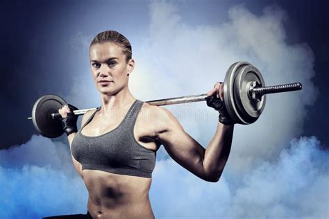 Composite Image Of Muscular Woman Lifting Heavy Barbell Stock Photo