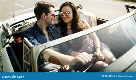 Couple Driving A Car Traveling On Road Trip Together Stock Photo