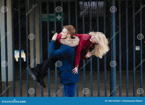 Guy On The Shoulder Is Carrying The Girl Winter Outdoors Stock Photo