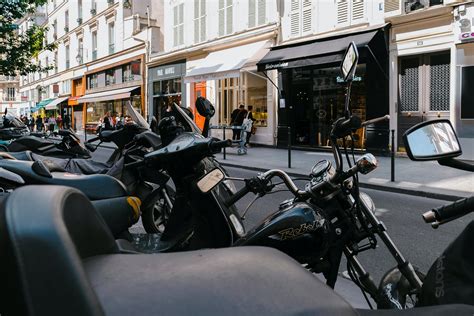 Photo Of Motorcycles Parked Near Buildings · Free Stock Photo