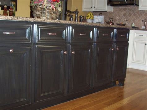 You will want to work in small areas, about 2'x2', and apply a thick coat of glaze. cabinet refinish/black cabinets/faux finish/wood finishes