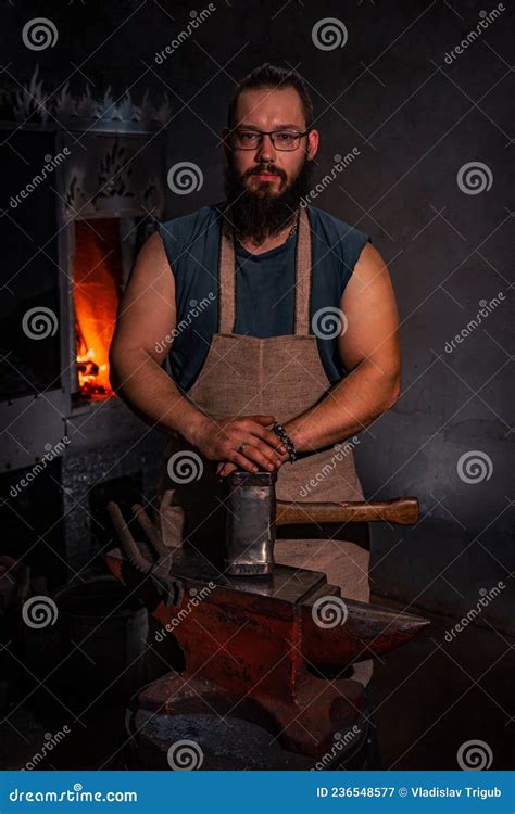 Portrait Of A Bearded Blacksmith In The Smithy A Blacksmith With Poor